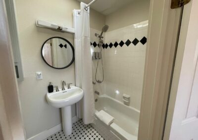 A modern black and white bathroom with a sink and tub